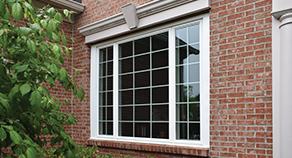 Stanek Windows with white trim on a white brick house