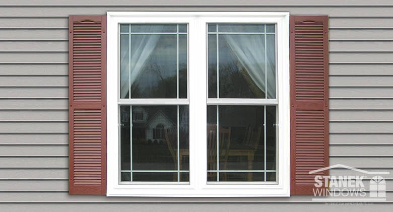 Stanek Windows with white trim and brown shutters