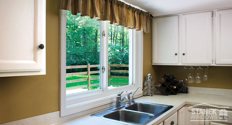 White framed two-lite sliding window over a kitchen sink