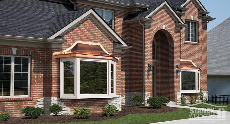 Stanek Windows bay window with a copper roof on a brick house