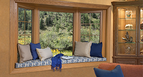 Bay window with a vase of sunflowers on the window sill.