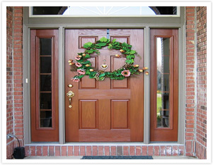 Entry Door with natural stained wood and brass door handle